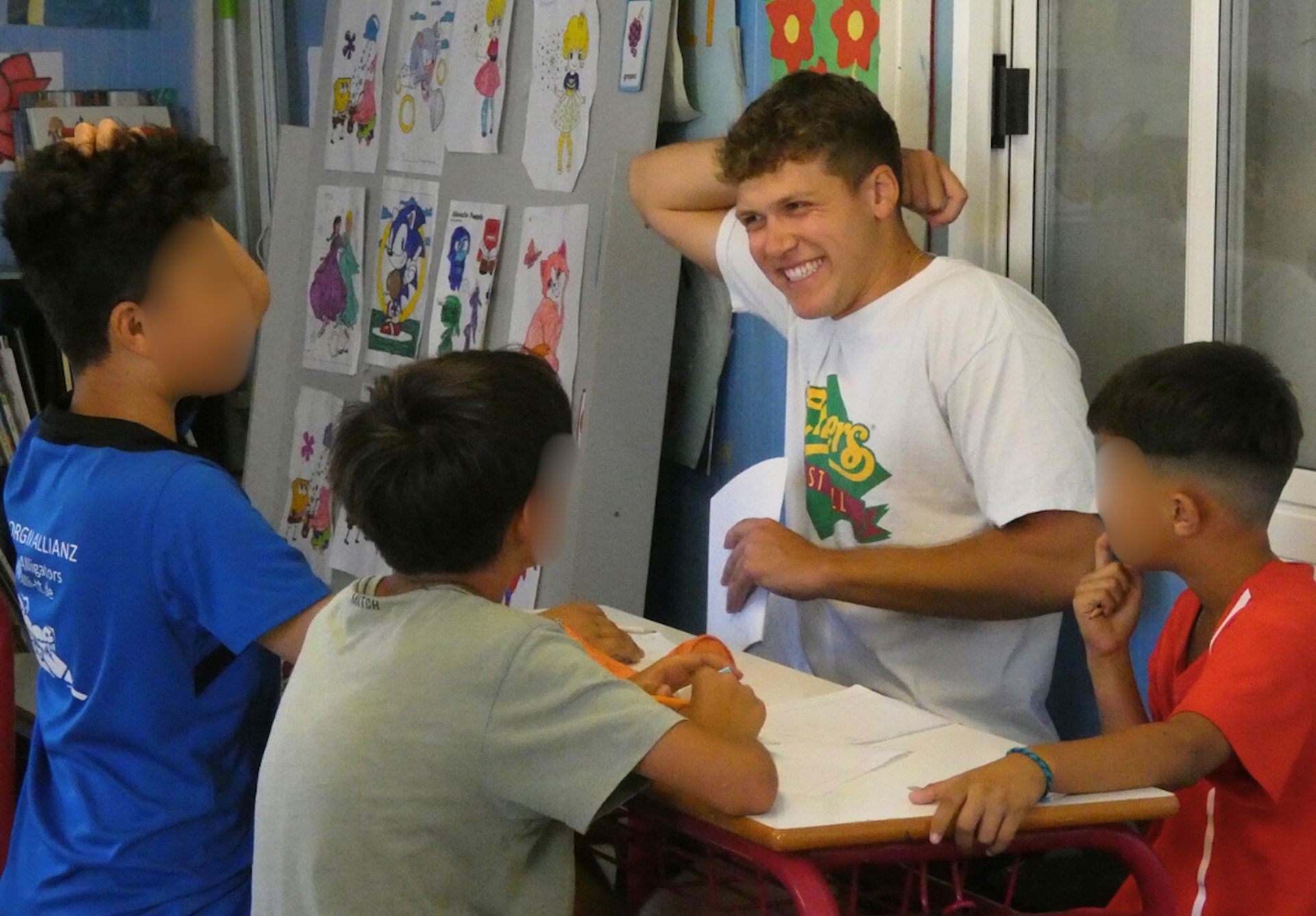 Greek America Corps volunteer working with children in a classroom