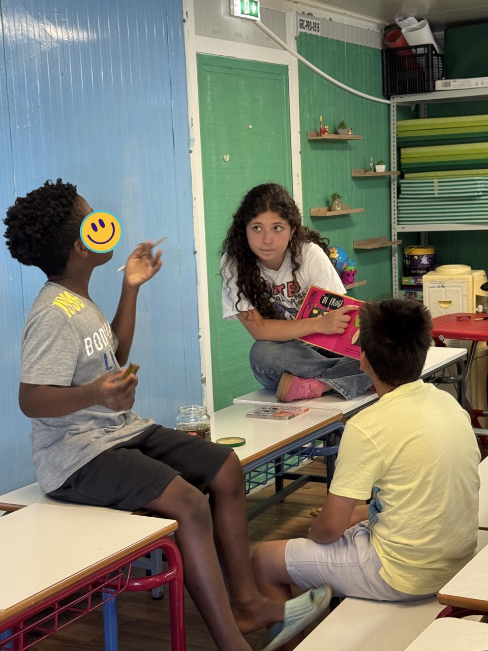 A volunteer holds a picture book during a small-group classroom activity.