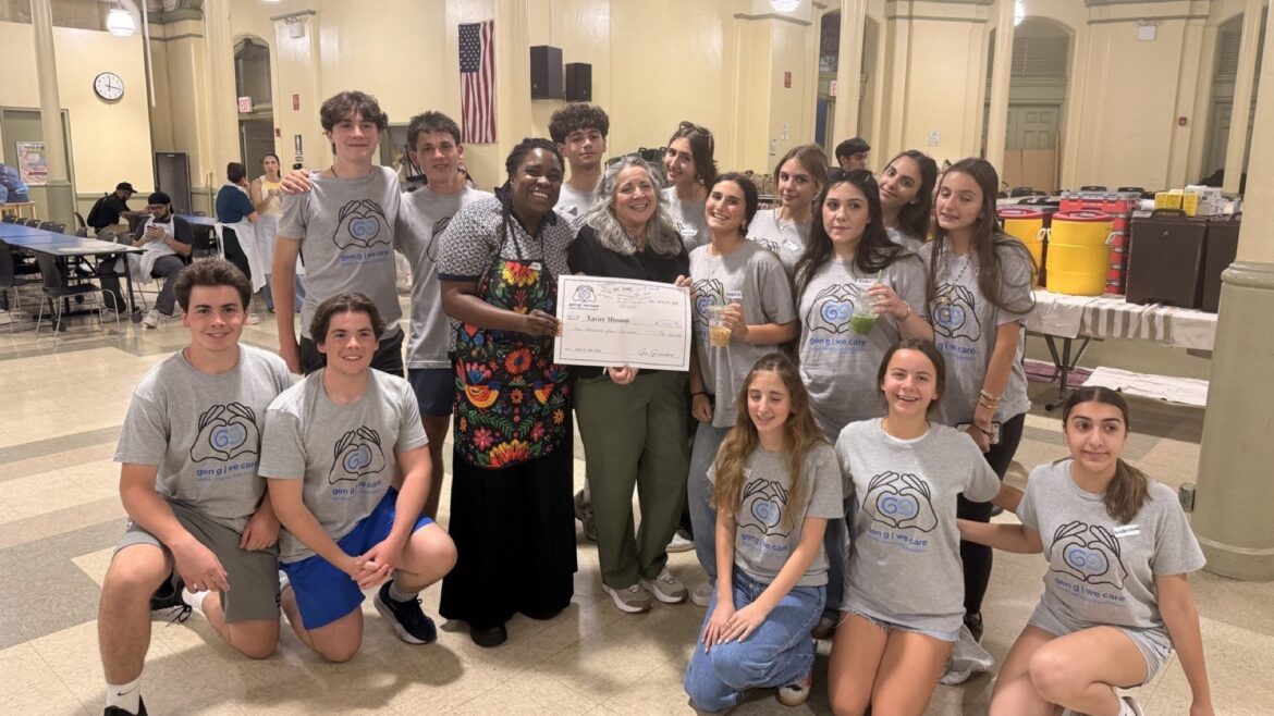 Gen G teens gather with adults around a donation check at Xavier Mission in New York City.