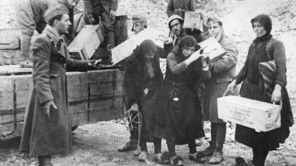 Women help Greek soldiers unload ammunition in Greece, 1941.