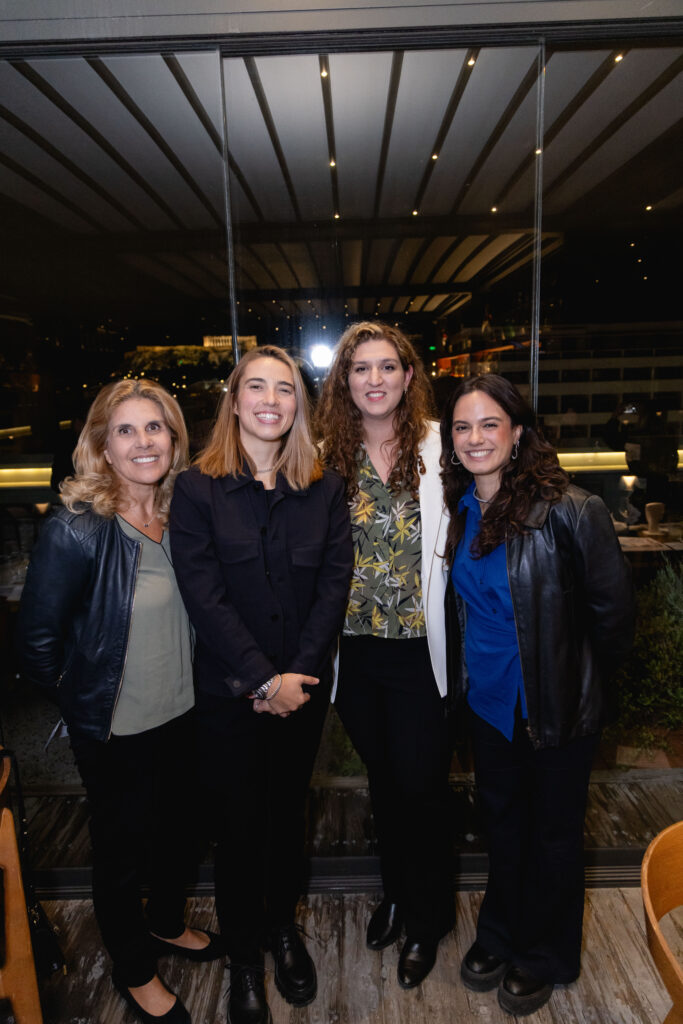 Four guests posing together at Olympias Rooftop.