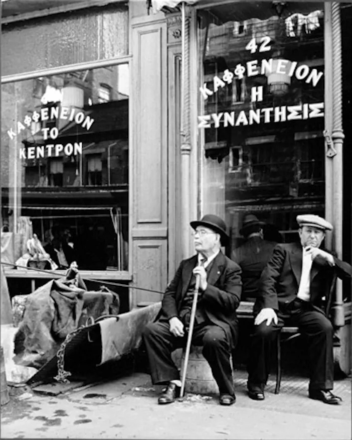 Men seated outside a Greek coffeehouse