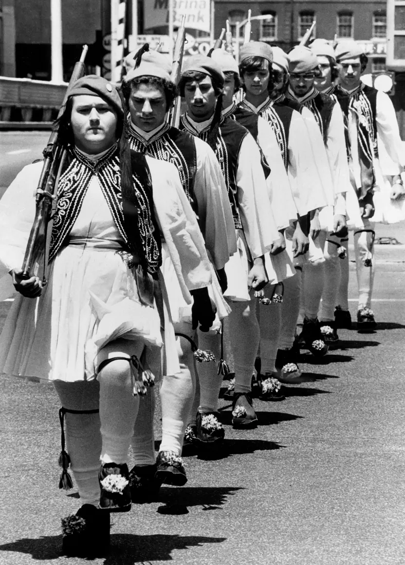 Archival photograph of a diagonal parade lineup in traditional Evzone dress