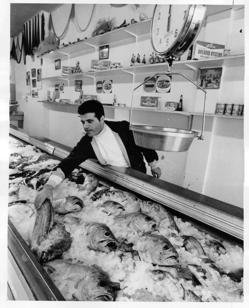 A fishmonger working behind his counter