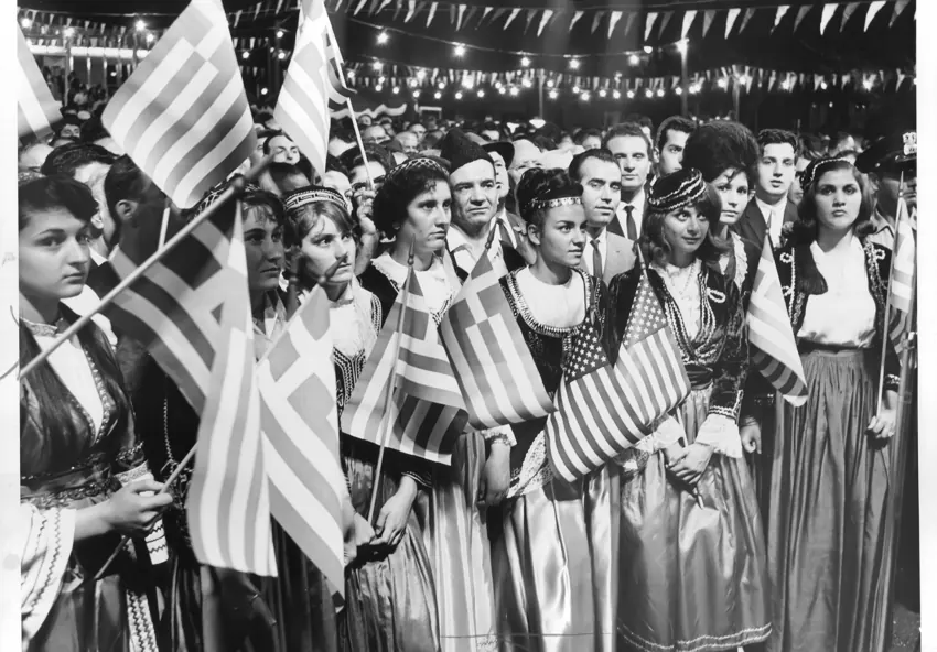 Parade participants gathered with Greek and American flags