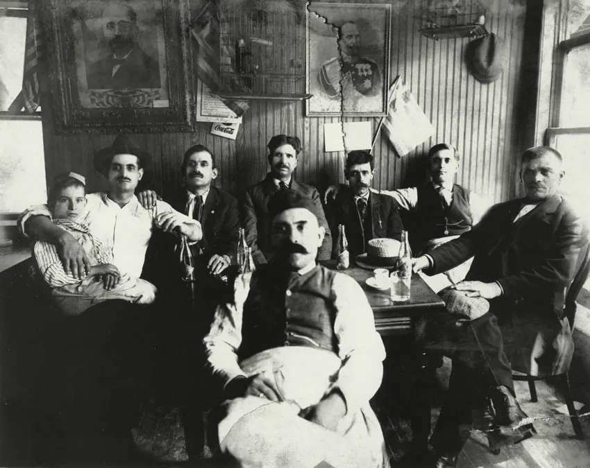 Men gathered in a neighborhood coffeehouse