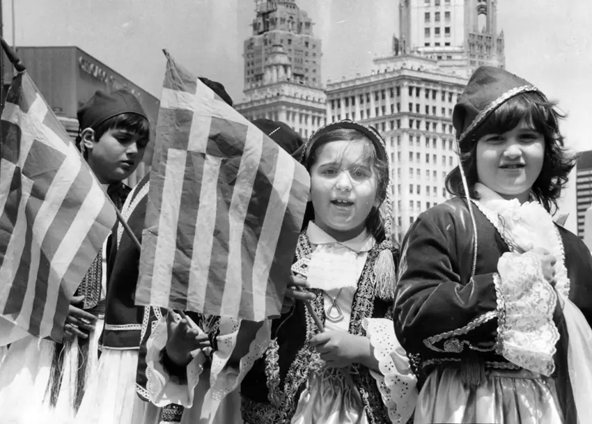 Children carrying Greek flags at a parade